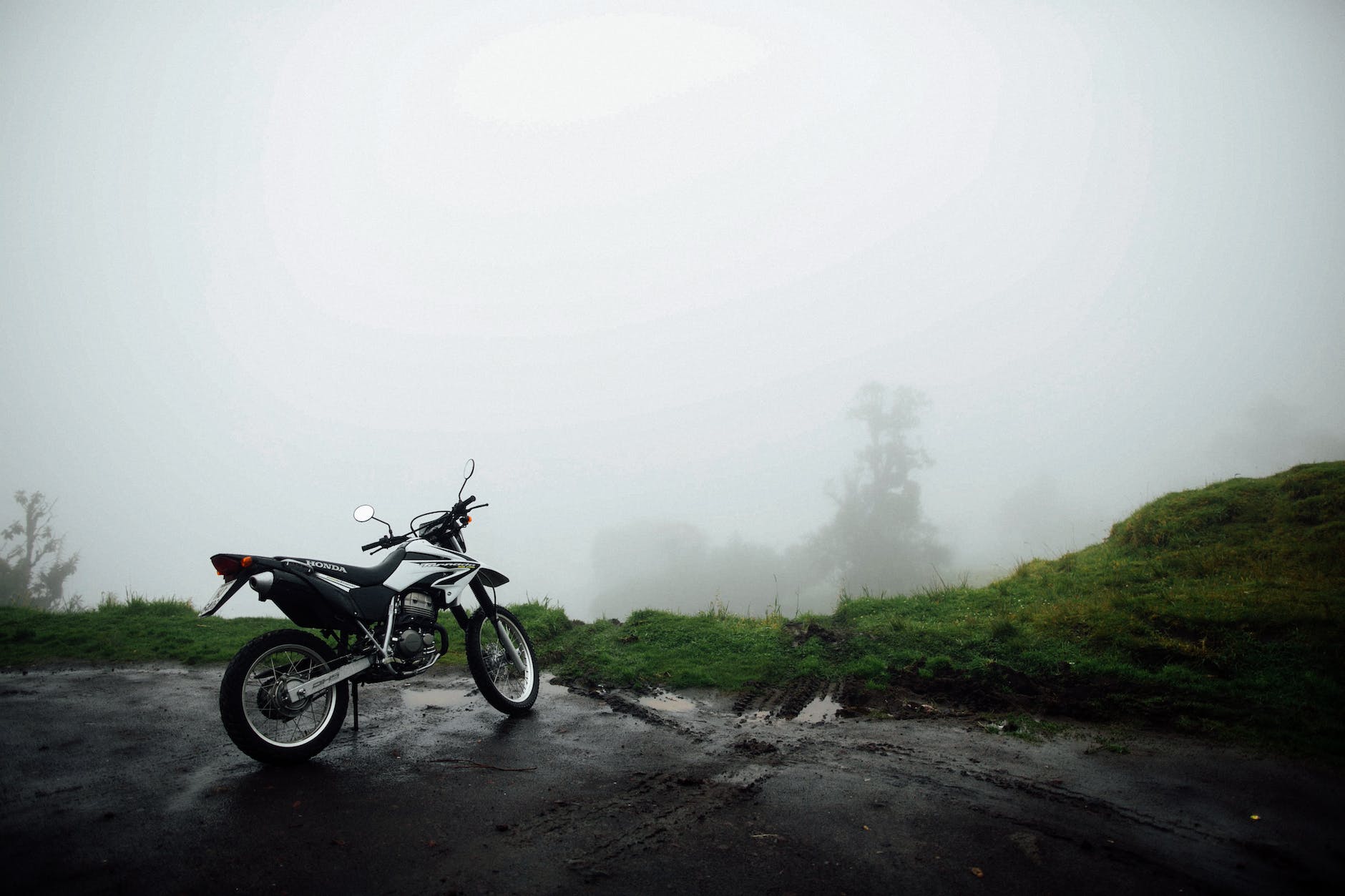 honda motorcycle parked near green field