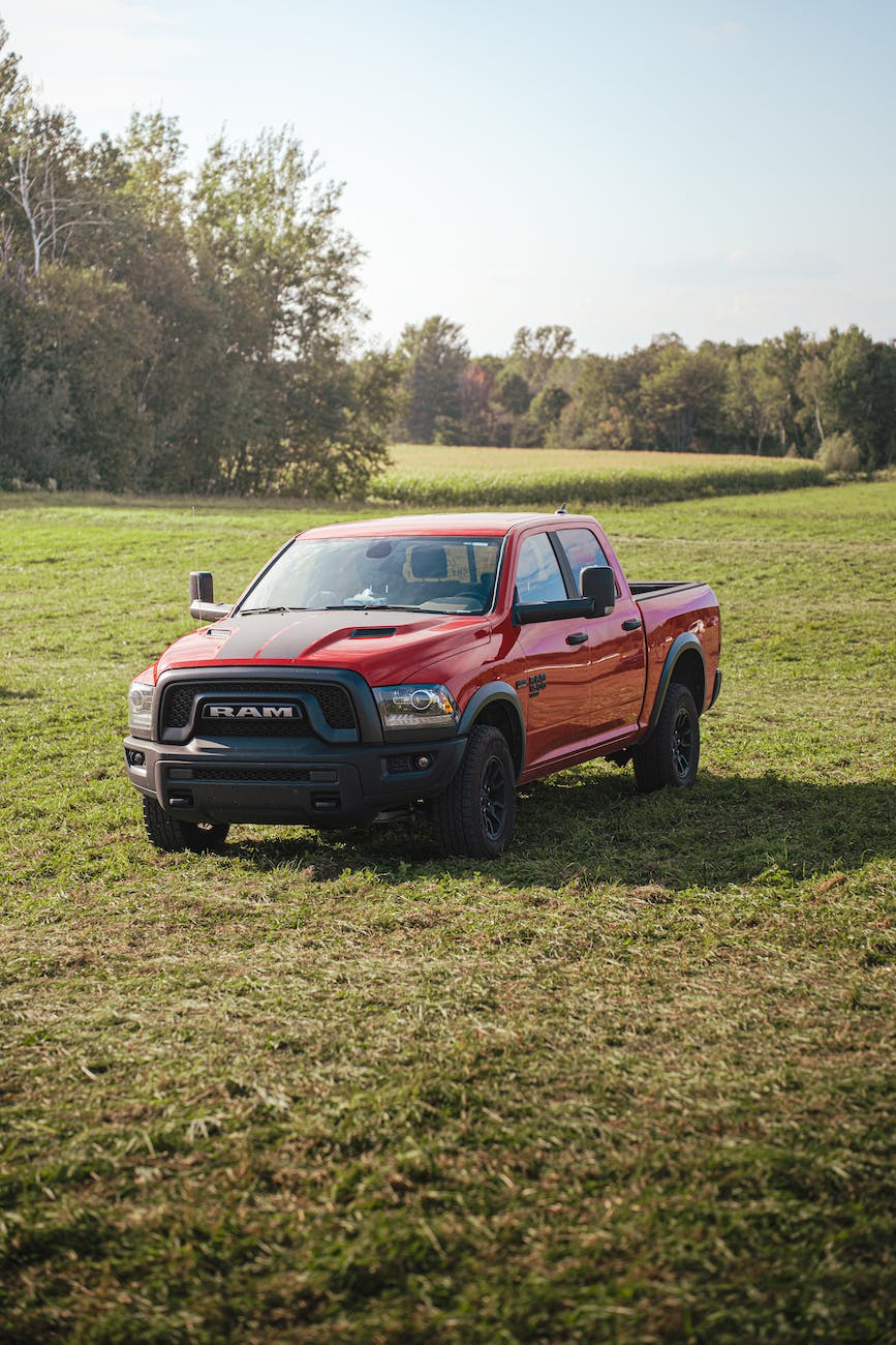 red pickup truck ram rebel parked in a pasture